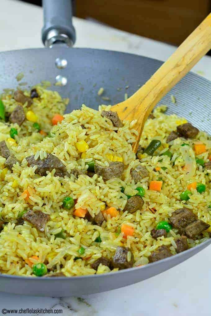 Close up picture of the delicious Nigerian Fried Rice loaded with mixed vegetables and beef Liver