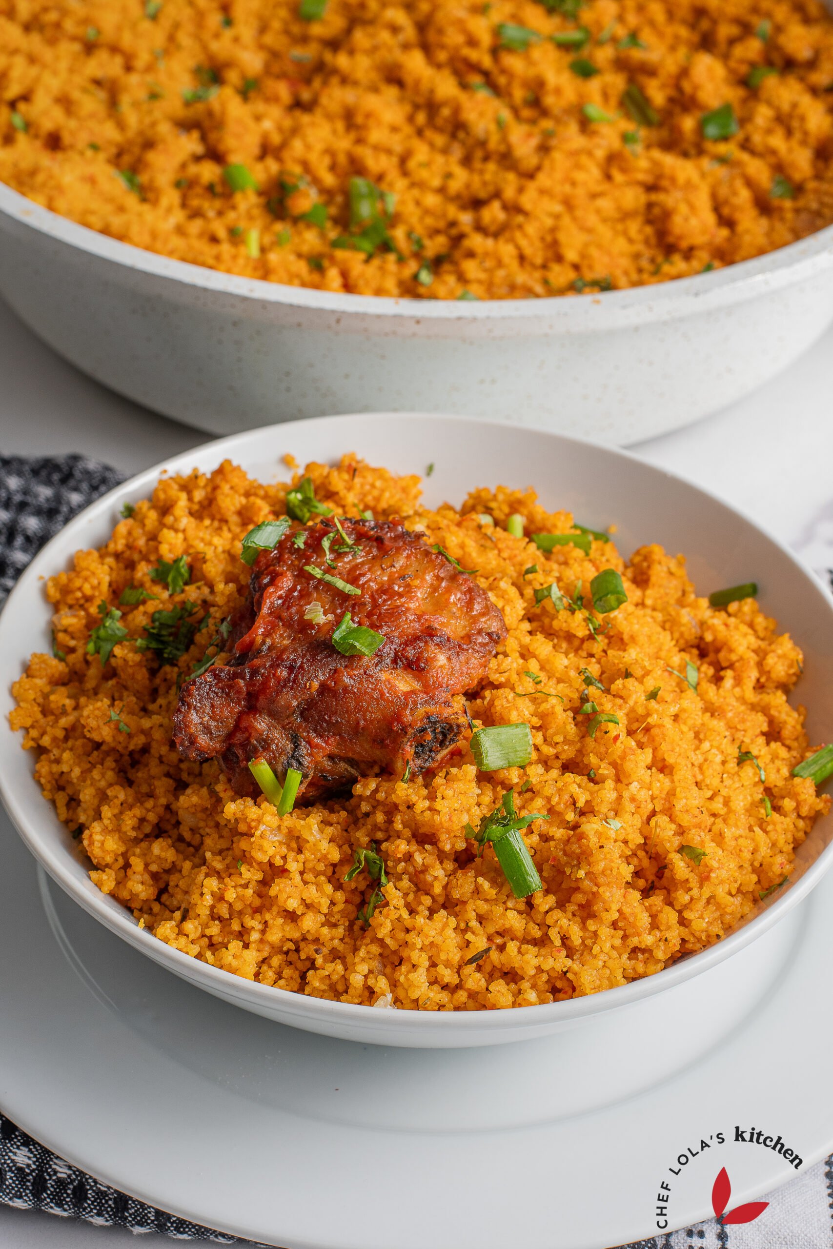 Vibrant and flavorful Jollof couscous dish garnished with herbs
