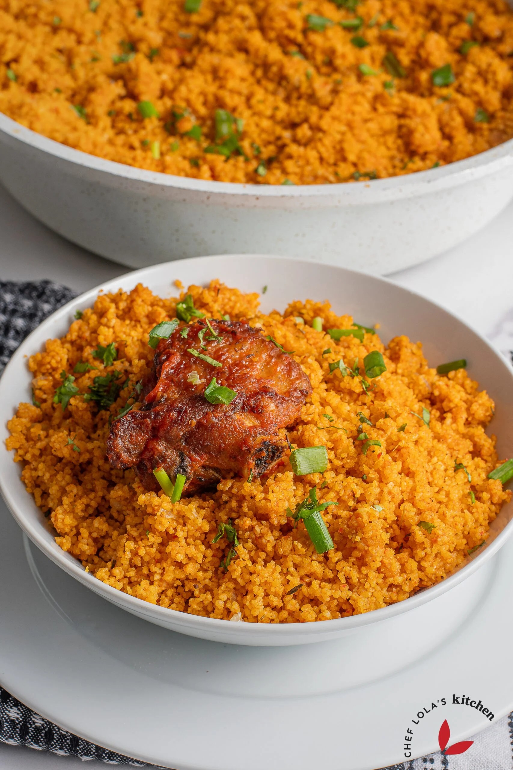 Vibrant and flavorful Jollof couscous dish garnished with herbs