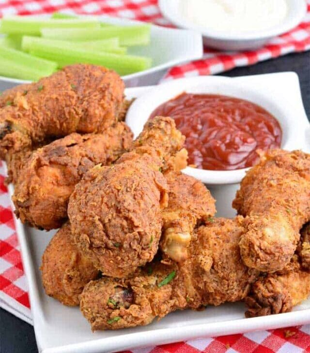 Crispy fried Chicken drumsticks with ketchup and celery sticks
