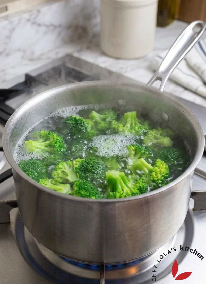 Broccoli florets boiling in a pot of water on the stovetop