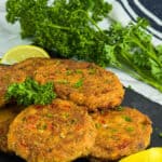 Salmon croquettes with lemon wedges and parsely