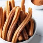 Homemade churros with brown sugar cinnamon placed in a bowl