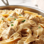 A close-up image of freshly cooked creamy chicken alfredo