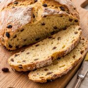 Rustic Irish soda bread loaf sliced into thick pieces and ready to serve.