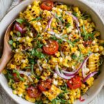 Sweet and smoky grilled corn salad with charred kernels and fresh diced vegetables.