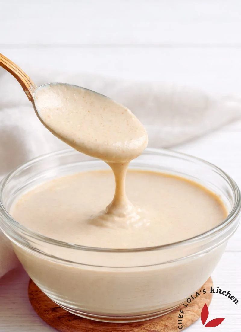 Freshly blended tahini with a smooth, pourable texture.