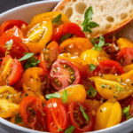 Tomato Bruschetta in a bowl, garnished with minced basil.