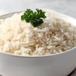 Reheated rice in a bowl garnished with parsley leaf