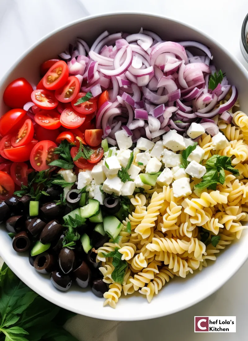 Ingredients for making pasta salad. Featuring: pasta, olives, red onions, tomatoes, basil, bell pepper