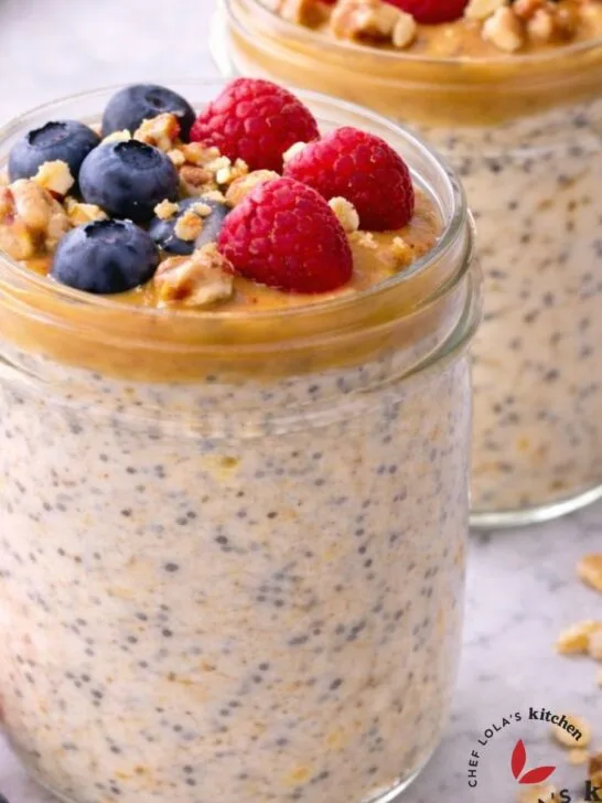 Overnight oatmeal porridge in a jar topped with fresh fruits and nuts