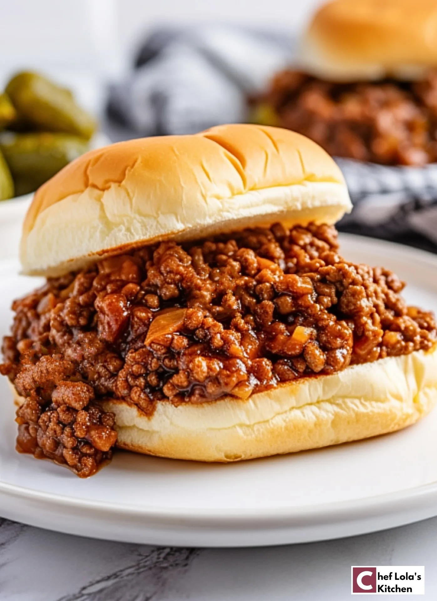 Close-up view of a homemade Sloppy Joe sandwich on a toasted bun.