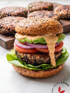 Delicious black bean burger with lettuce, tomato, and a whole-grain bun.