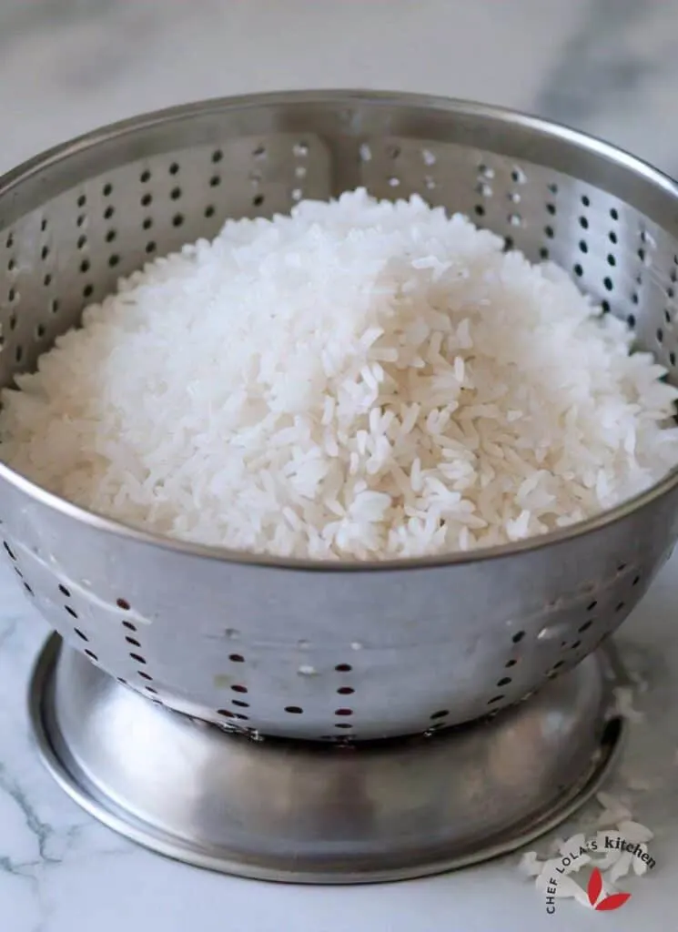Parboiled rice in a colander showing it's well separated grains