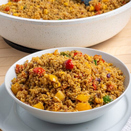 Fonio stir fry with colorful bell peppers, and onions, served hot and steaming