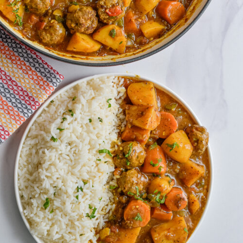 Comforting one-pot dish featuring meatballs, potatoes, carrots, and sauce