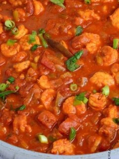 Shrimp creole in a pan garnished with green onions
