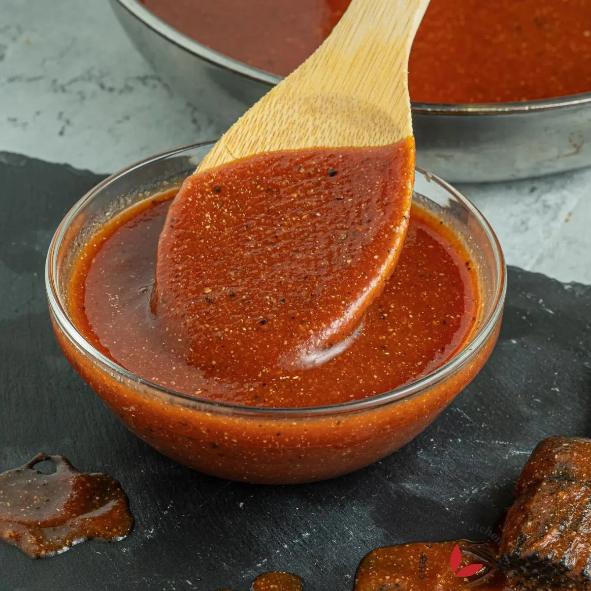 Homemade Barbecue sauce scooped with a wooden spoon