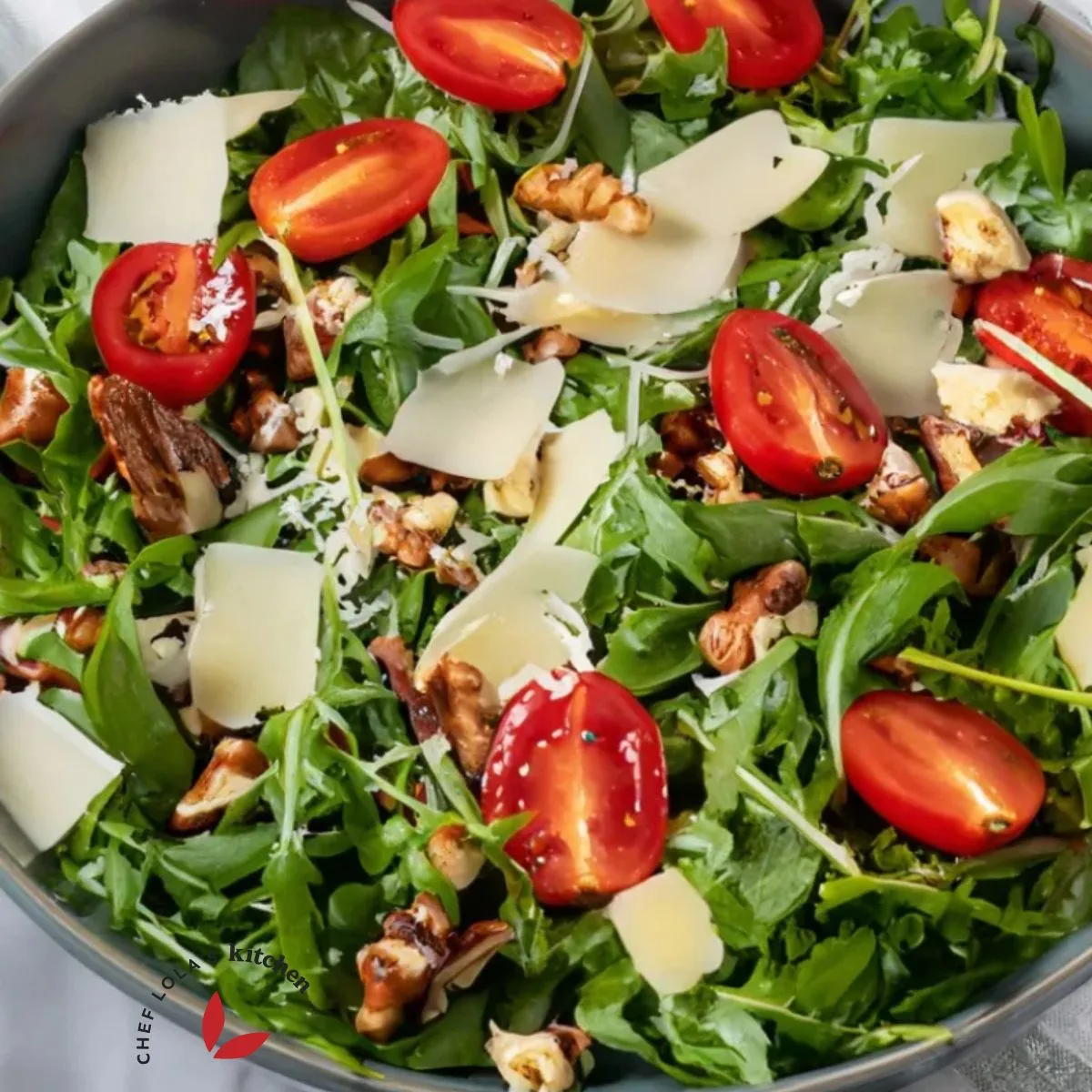 Close-up image of crisp, fresh arugula salad with vinaigrette dressing.
