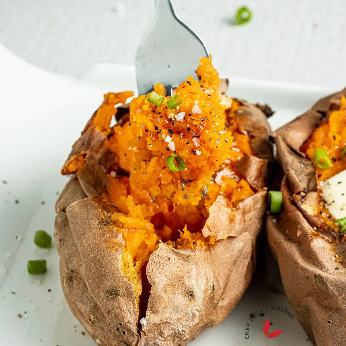 Baked sweet potato beautifully scooped with a fork.