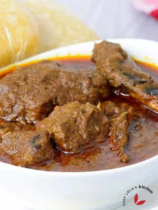 Banga Soup with meat served in a white bowl