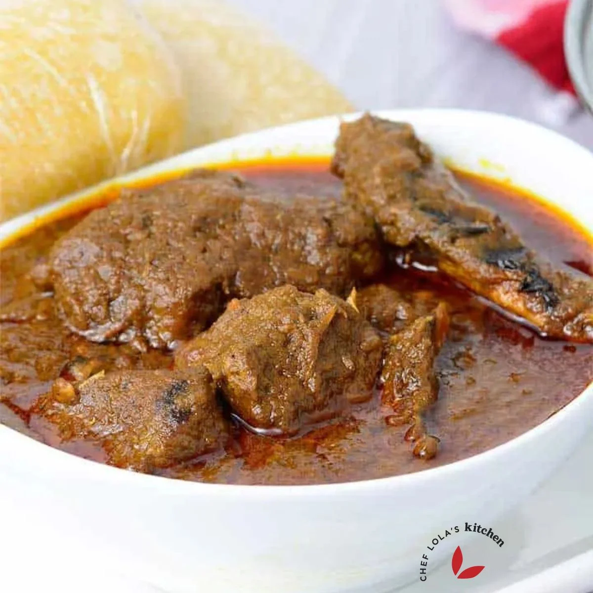 Banga Soup with meat served in a white bowl