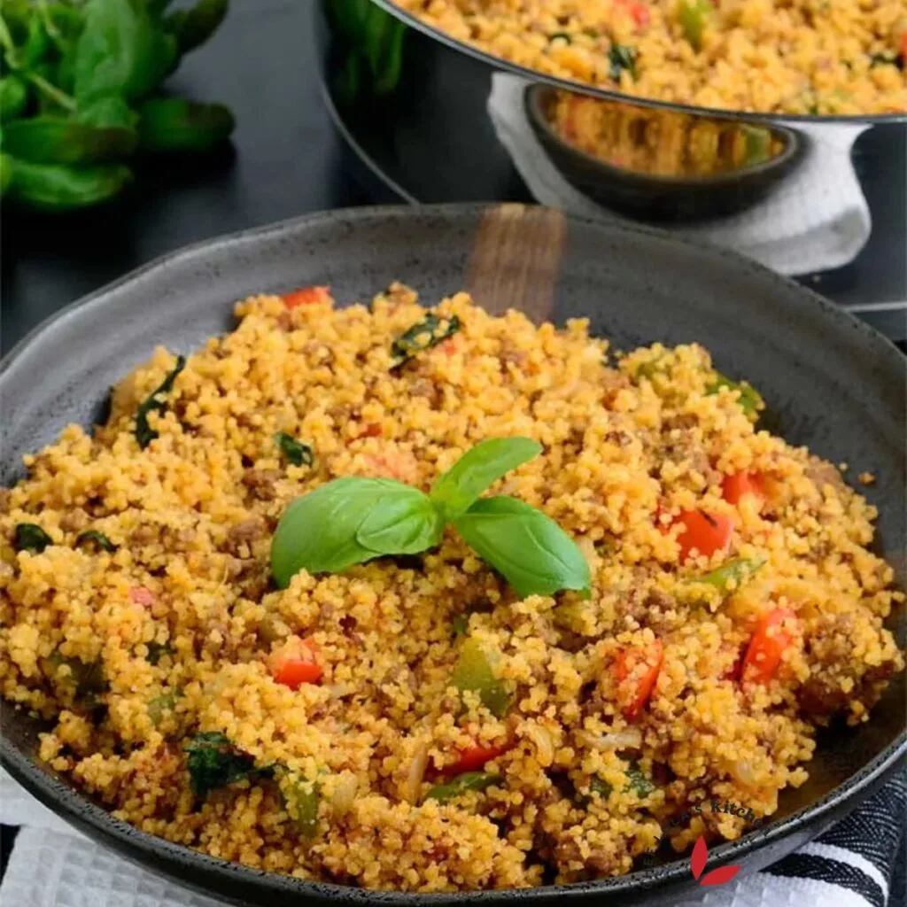Couscous served in a bowl and garnished with basil.