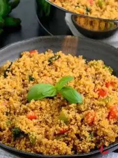 Couscous served in a bowl and garnished with basil.