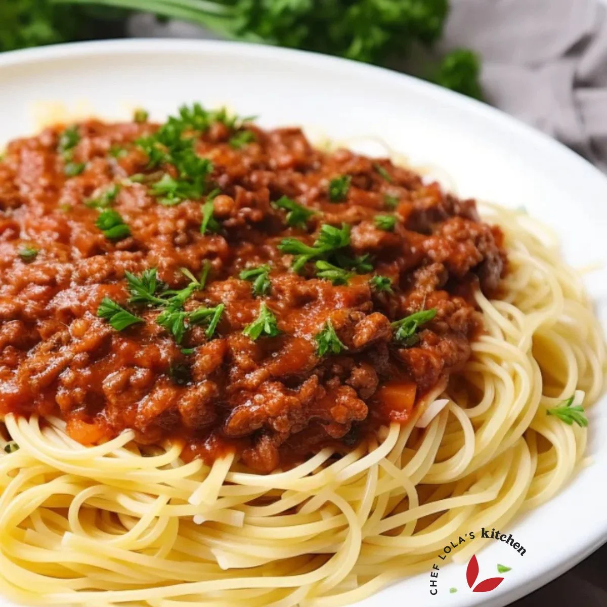 A comforting plate of pasta topped with a hearty serving of Bolognese sauce.