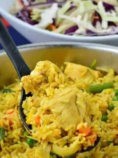 Nigerian chicken fried rice scooped on a spoon