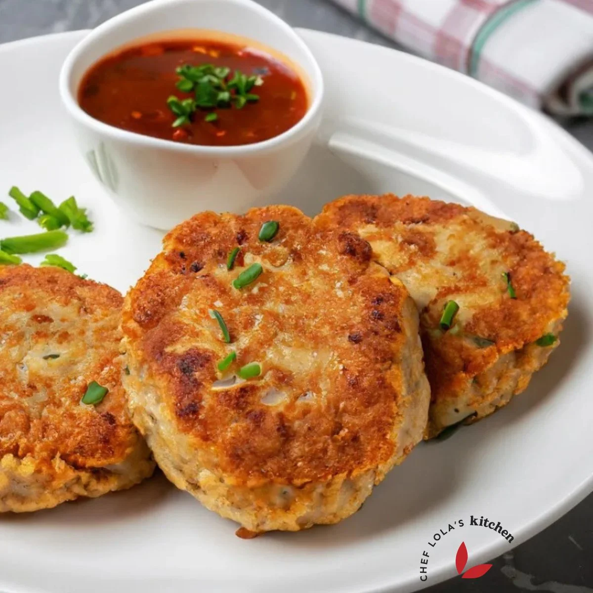 Golden brown chicken patties served with a dip on a plate
