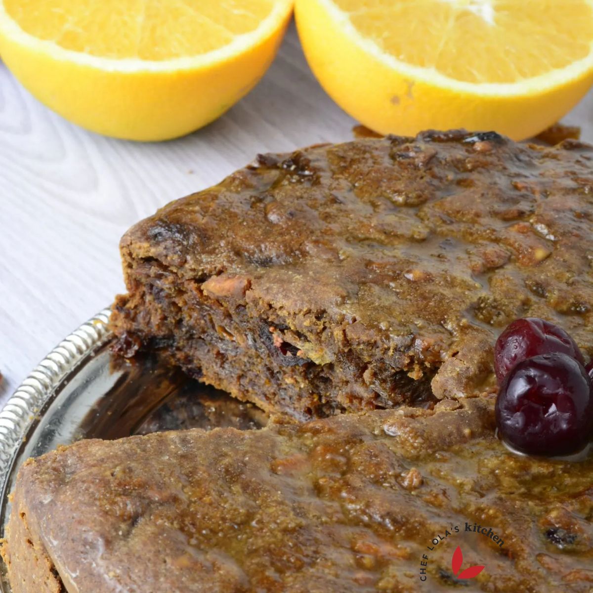 Freshly baked Christmas fruit cake decorated with bright red cherries