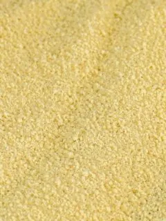 Homemade couscous preparation with semolina flour and water