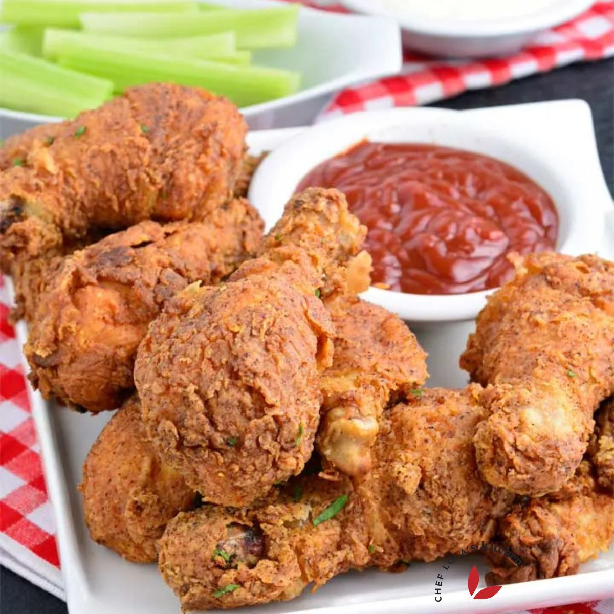 Crispy fried Chicken drumsticks with ketchup and celery sticks