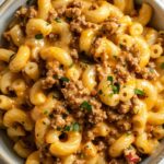 A delicious pasta dish with ground beef and melted cheddar cheese.
