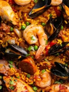 Colorful Spanish paella featuring chicken, chorizo, and vegetables.