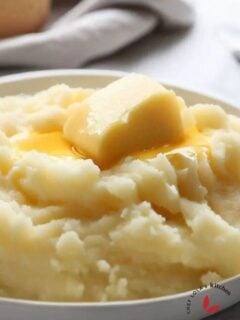 Reheated mashed potatoes with a slice of butter