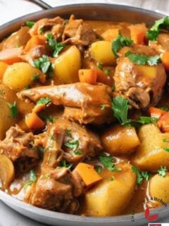 Delicious homemade Jamaican curry chicken cooked in a skillet and garnished with parsley.