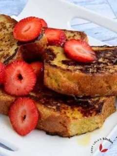 French Toast drizzled with honey and garnished with strawberries