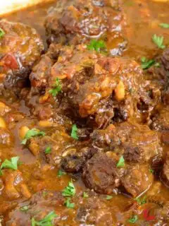 Jamaican oxtail stew garnished with parsley