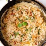 Marry me chicken garnished with herbs and dry chili