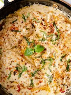 Marry me chicken garnished with herbs and dry chili