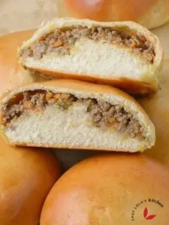Freshly baked Meat Buns sliced into two to show the delicious meat filling