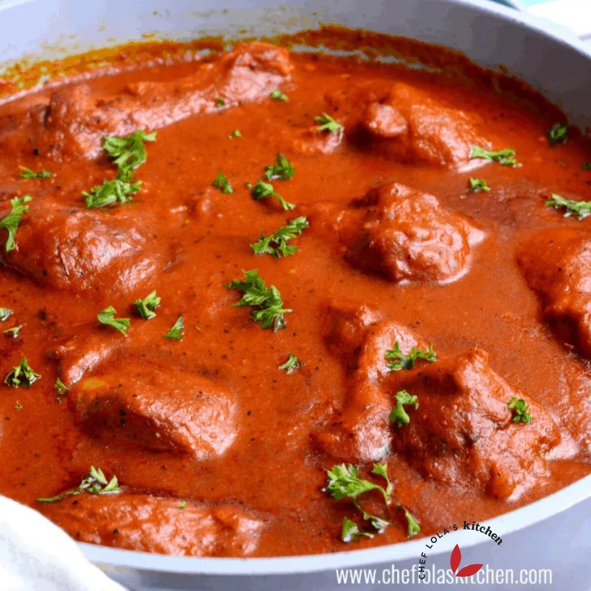 A pot of Chicken Stew garnished with parsley