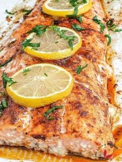 Oven baked Salmon fish garnished with lemon slices