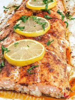 Oven baked Salmon fish garnished with lemon slices