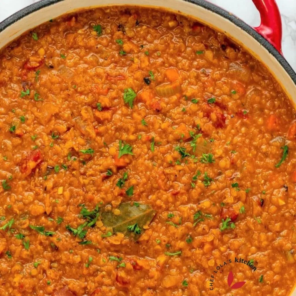Freshly cooked red lentil soup garnished with parsley