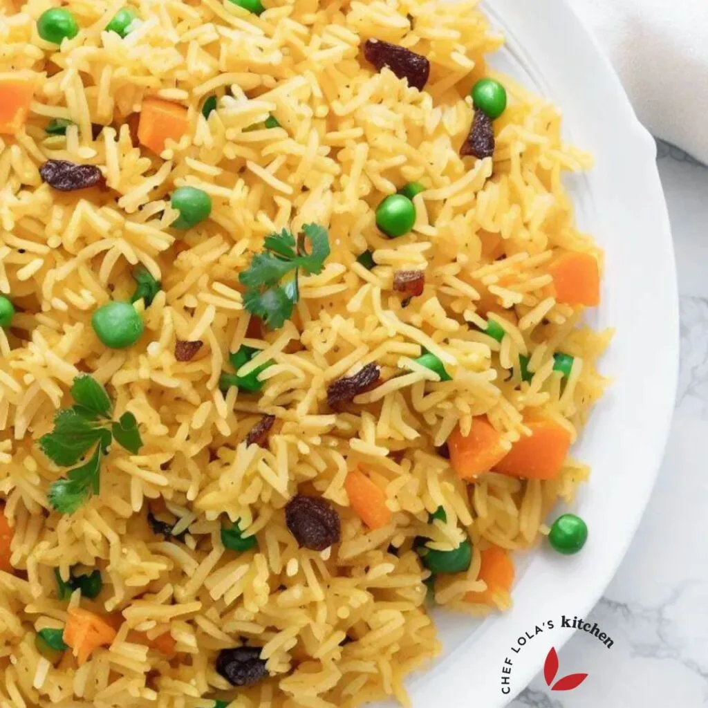 Rice pilaf made with saffron, peas, and raisins. Served in a plate and garnished with parsley