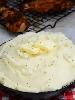 Roasted Garlic Mashed Potatoes served in a bowl and topped with butter