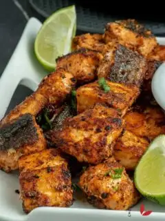 Delicious salmon bites garnished with lemon wedges